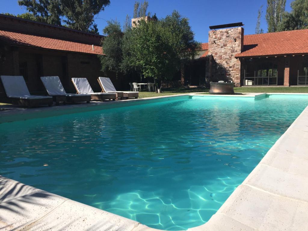 a swimming pool with lounge chairs in the water at Suter Petit Hotel in San Rafael