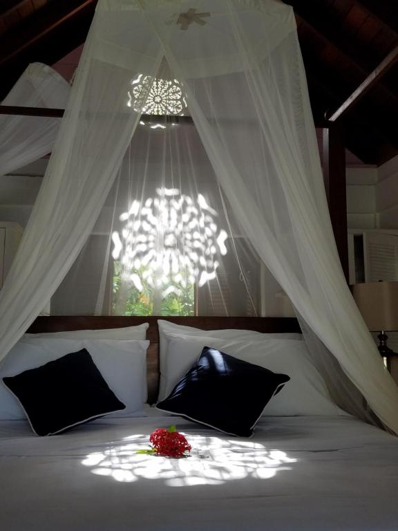 a bedroom with a bed with a chandelier at Gingerbread Suites in Port Elizabeth
