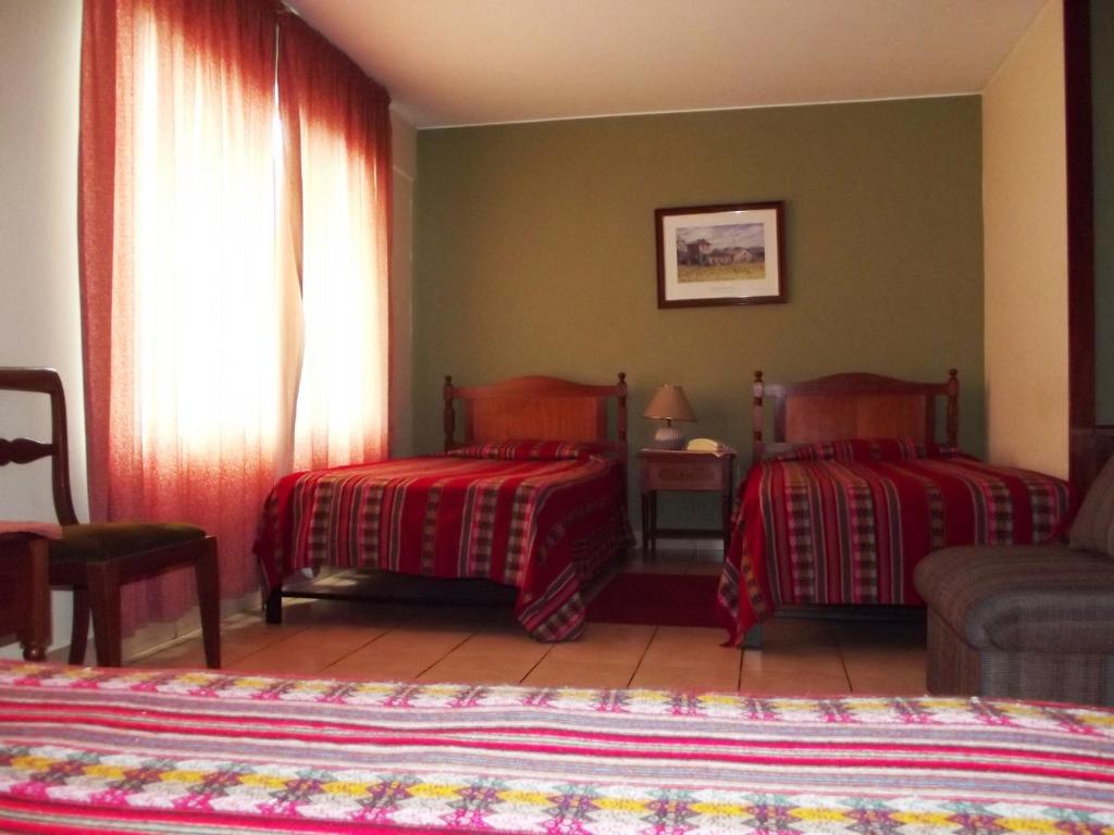 Postel nebo postele na pokoji v ubytování Hostal Gemina