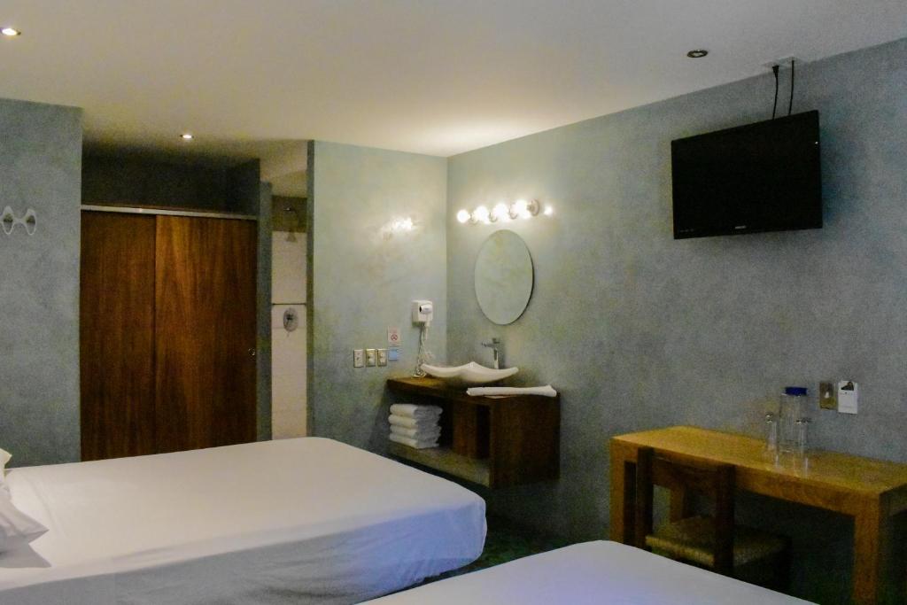 Postel nebo postele na pokoji v ubytování Hotel Rio Malecon