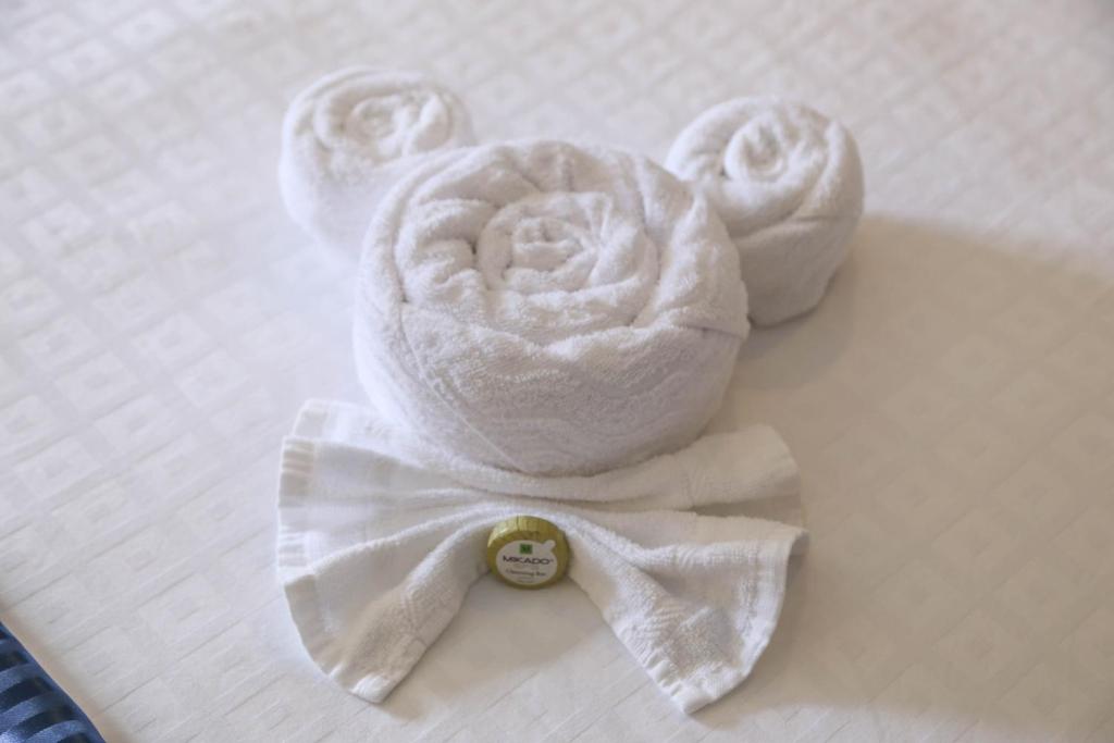 a towel animal with a bow tie on a bed at Destiny Palms Hotel Maingate West in Kissimmee