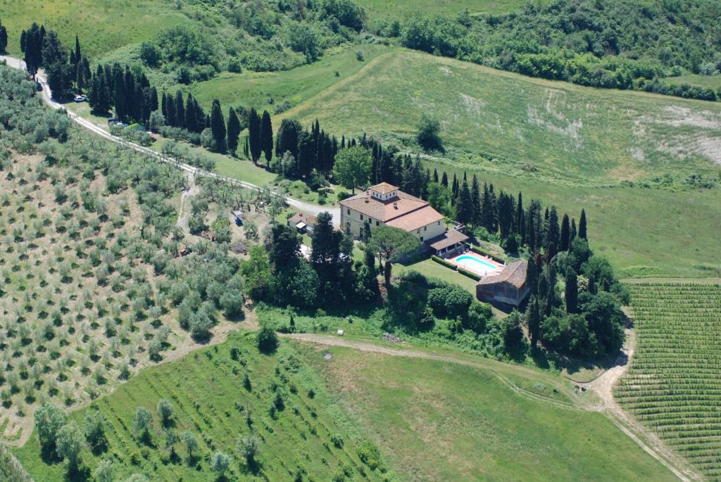 an aerial view of a house on a hill with trees at Agriturismo I Moricci in Peccioli