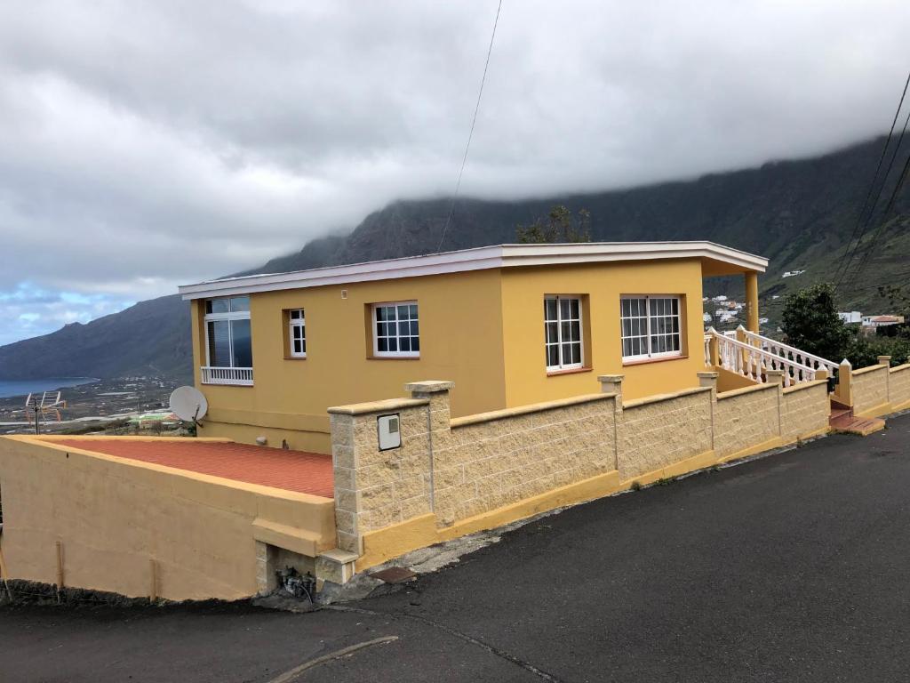 a yellow house on the side of a street at VV La Escondida in Frontera