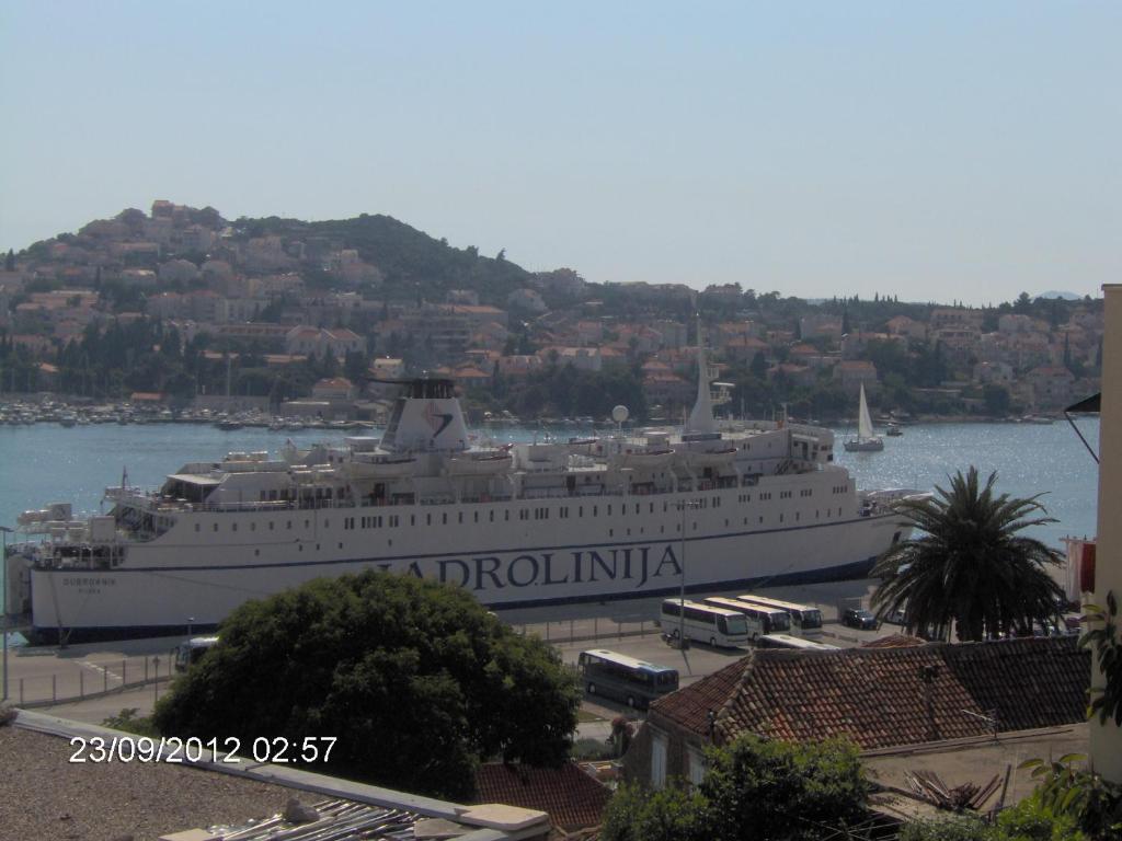 a large cruise ship is docked in the water at Apartments Grebović in Dubrovnik