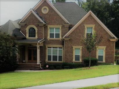 a brown brick house with at Elegant Jewel in Lithonia