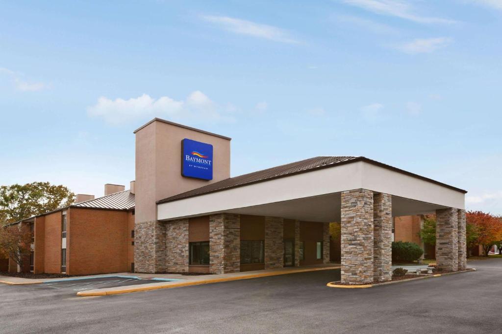 a building with a sign on the front of it at Baymont by Wyndham Rocky Mount in Rocky Mount