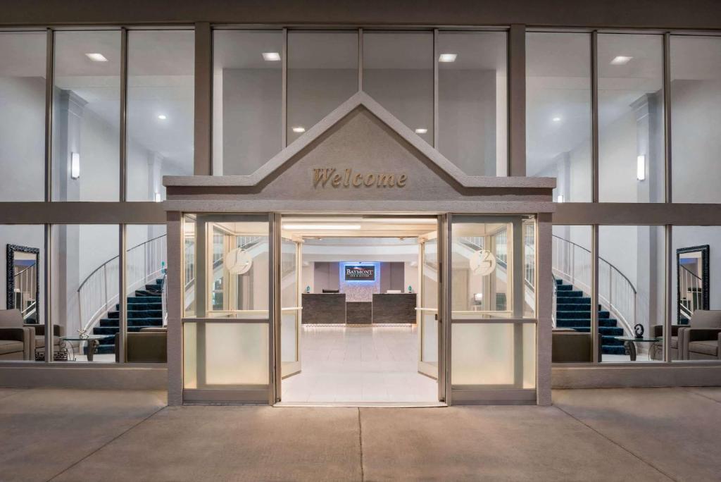 a entrance to a building with a welcome sign on it at Baymont by Wyndham Des Moines North in Des Moines