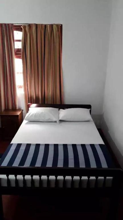 Postel nebo postele na pokoji v ubytování Olivia HomeStay