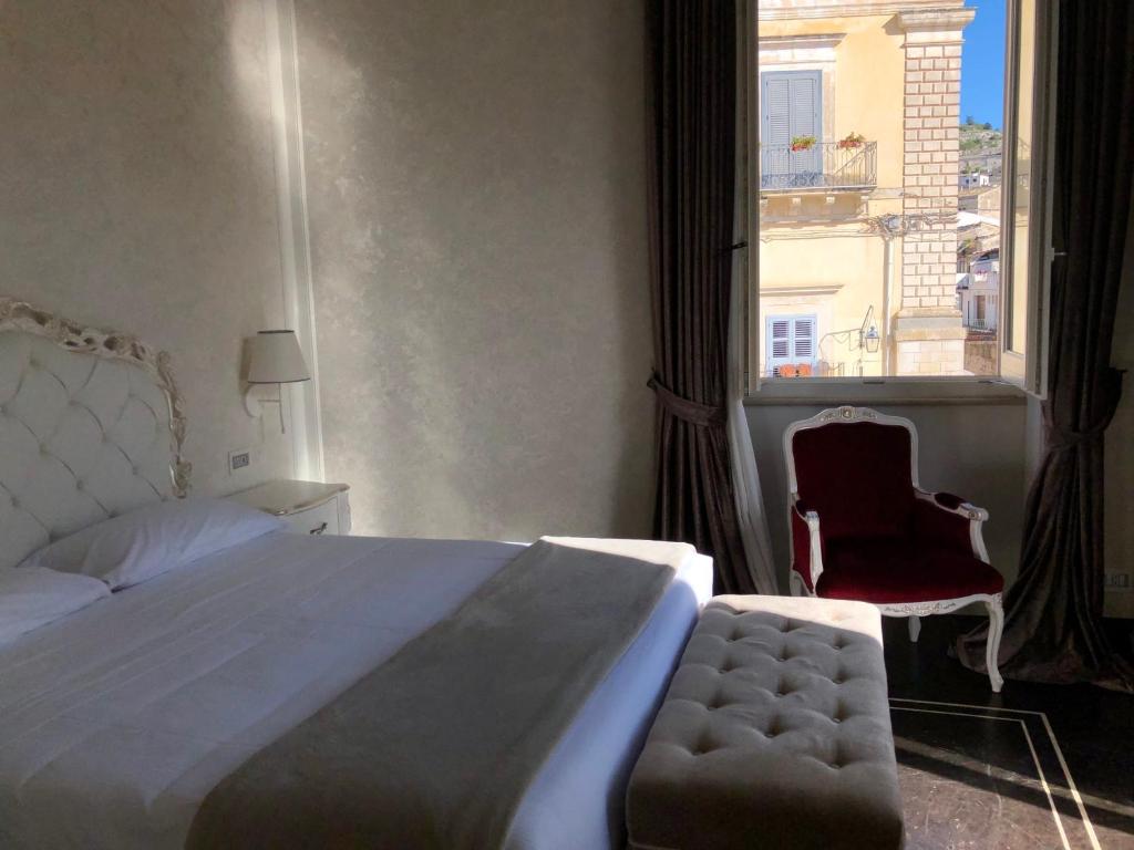 Postel nebo postele na pokoji v ubytování Palazzo Favacchio - Patanè
