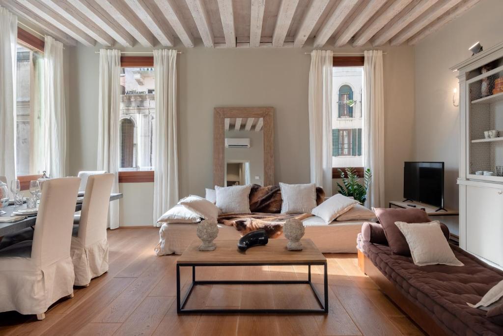 a living room with a couch and a table at Bridge of Sighs Luxurious Apartment in Venice