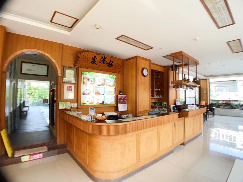 a restaurant with a counter in a room at Li Quan Hot Spring Resort in Baihe