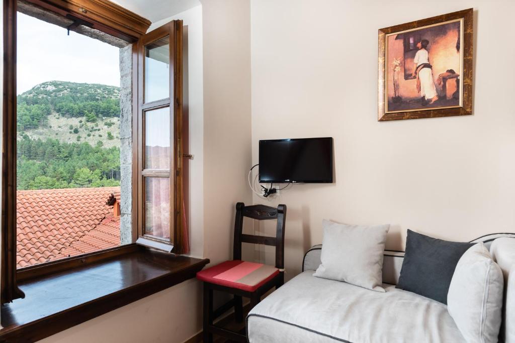 Televízia a/alebo spoločenská miestnosť v ubytovaní Kaza Guesthouse