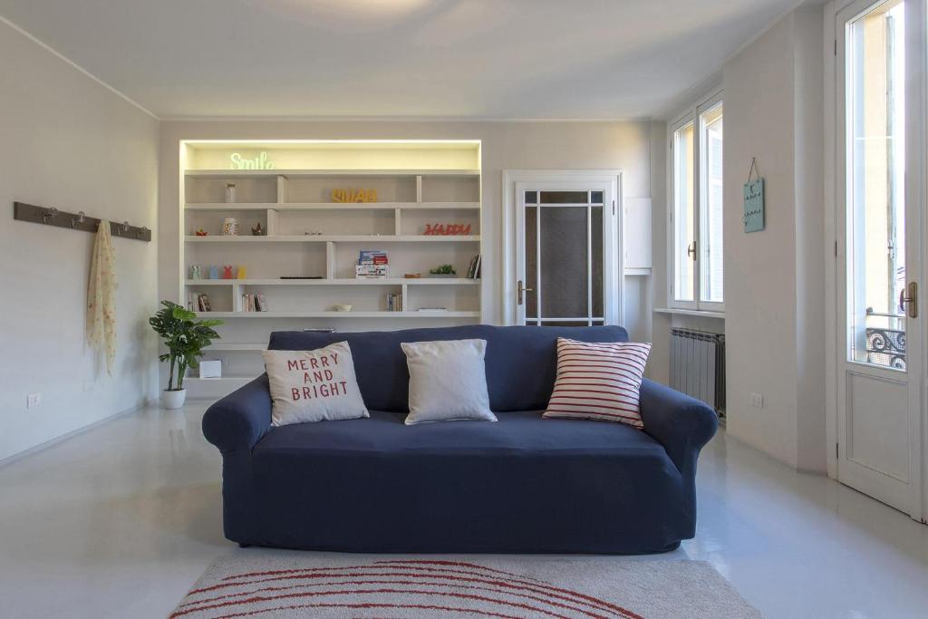 a blue couch in a living room with pillows on it at Casa ALBERTINI in Como