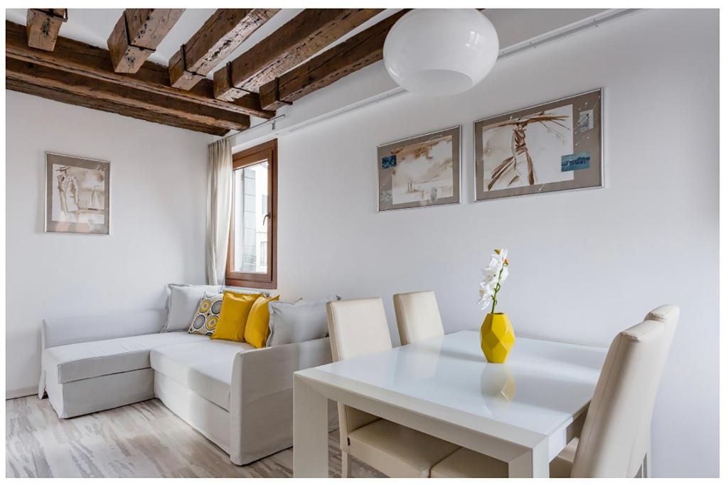 a white living room with a white table and a white couch at Biennale Family Apartment in Venice in Venice