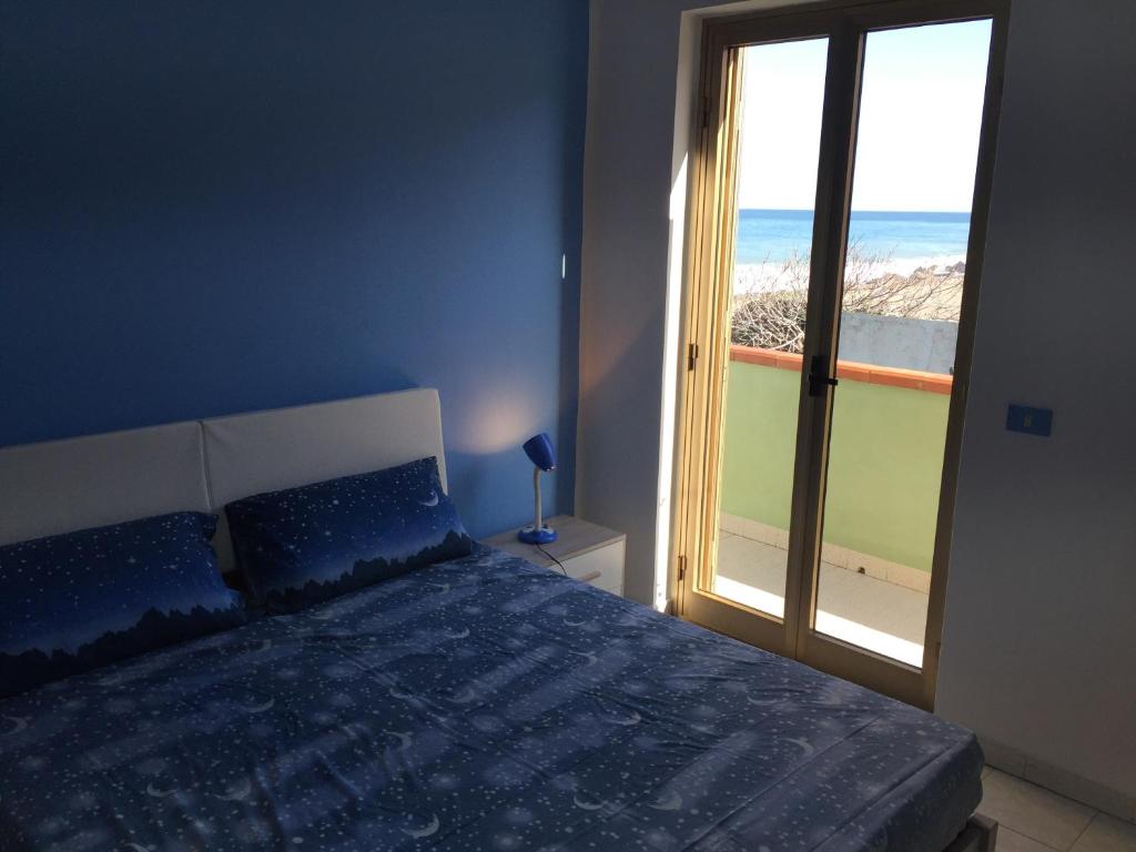 1 dormitorio con 1 cama y vistas al océano en Apartment Xenia, en Mongiove