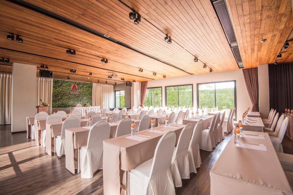 a banquet hall with white tables and chairs at Amanta Hotel Nongkhai in Nong Khai