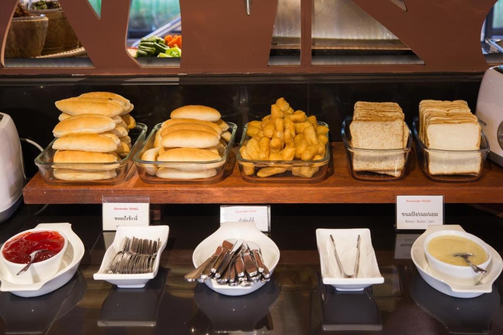 a display case with sandwiches and other food items at Amanta Hotel Nongkhai in Nong Khai