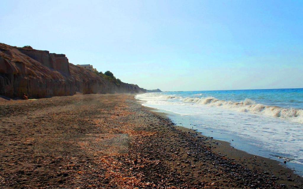 a beach with a rocky shore and the ocean at Ariana Eco Suites Adults Only in Fira