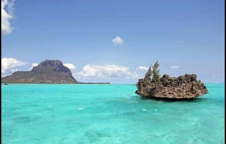 a small rock in the water in the ocean at View on Ilot Fourneau in Le Morne