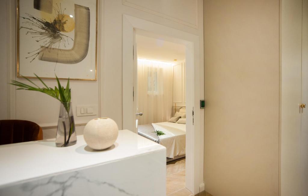 a room with a vase on a counter with a bedroom at Club boutique rooms in Split