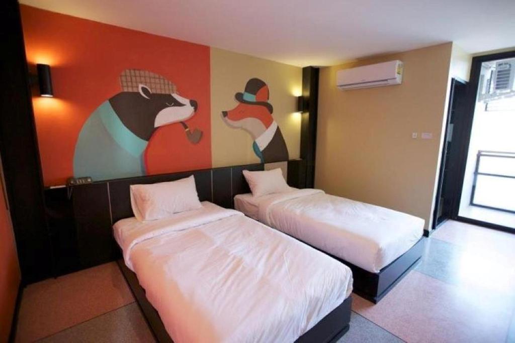 Postel nebo postele na pokoji v ubytování Pen Ta Hug Hotel