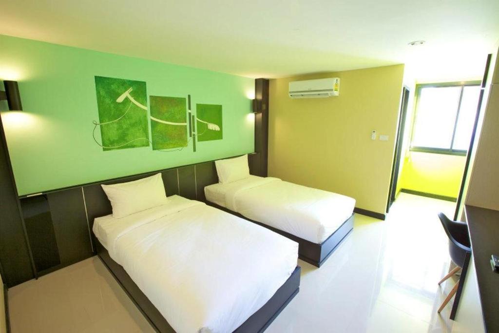 Postel nebo postele na pokoji v ubytování Pen Ta Hug Hotel