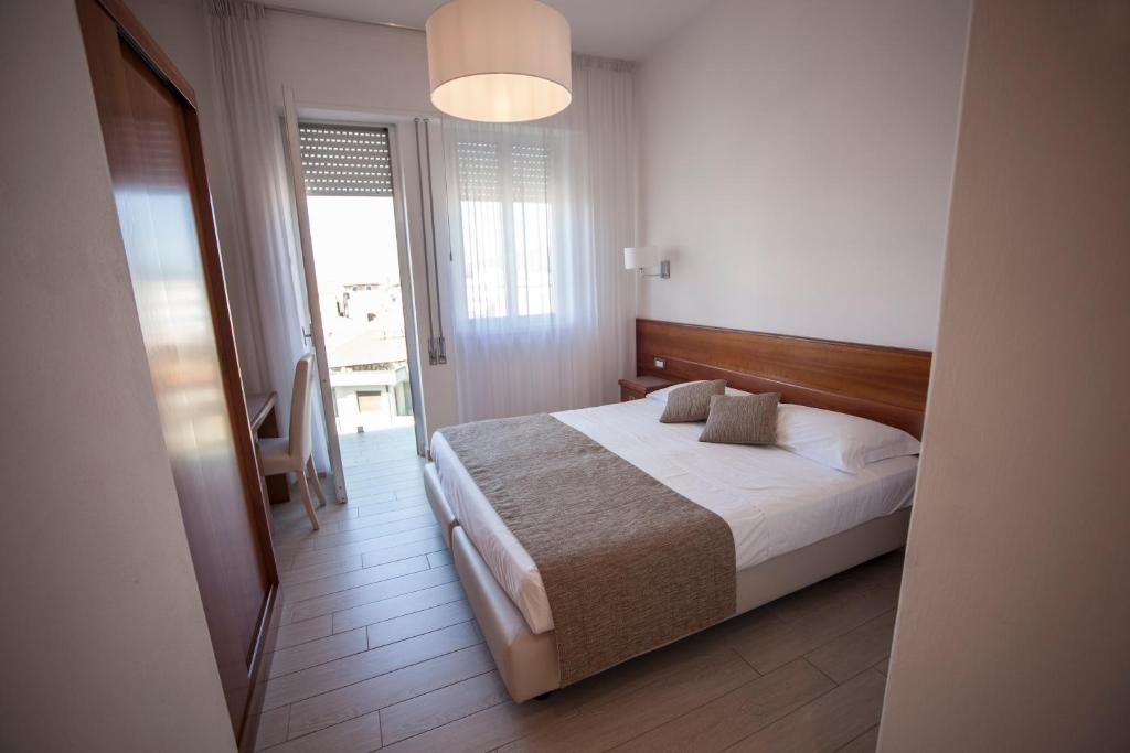 Postel nebo postele na pokoji v ubytování Hotel Pineta Mare