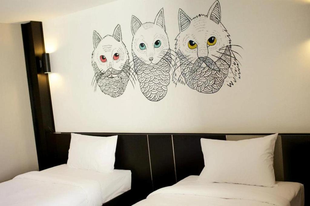 Postel nebo postele na pokoji v ubytování Pen Ta Hug Hotel