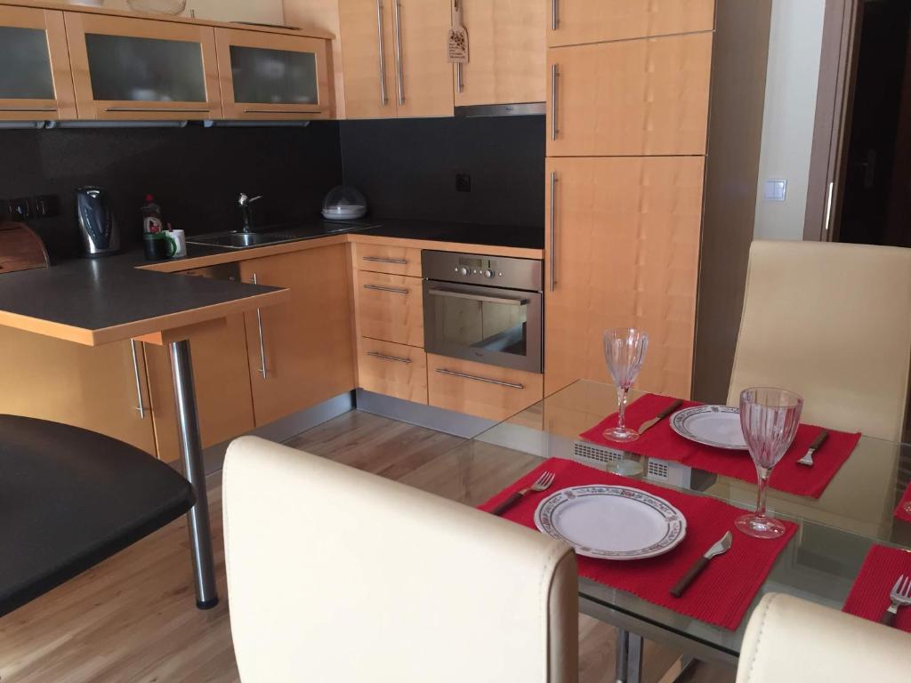 a kitchen with a table with two glasses on it at Apartmán Lipno in Lipno nad Vltavou