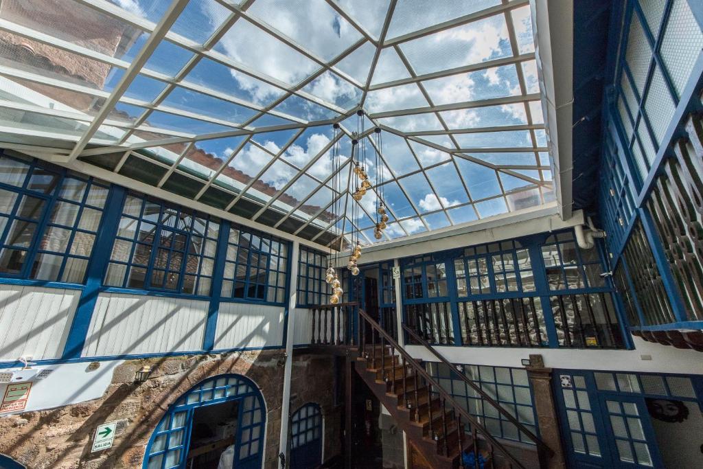 an empty building with a glass ceiling and stairs at X.O Art House in Cusco