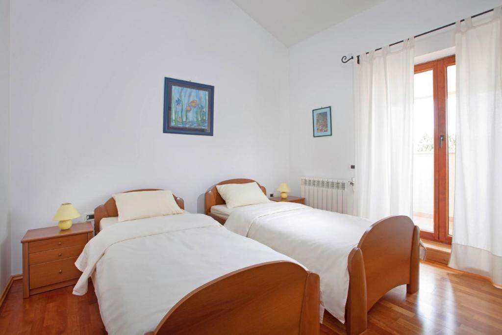 Postel nebo postele na pokoji v ubytování Villa Aurata in Ližnjan (Haus für 8-9 Personen)
