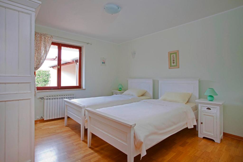 Postel nebo postele na pokoji v ubytování Villa Aurata in Ližnjan (Haus für 8-9 Personen)