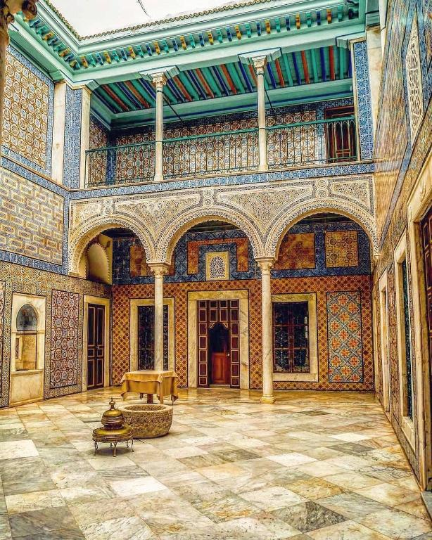 a large room with a stone floor and a large ceiling at Palais Bayram in Tunis
