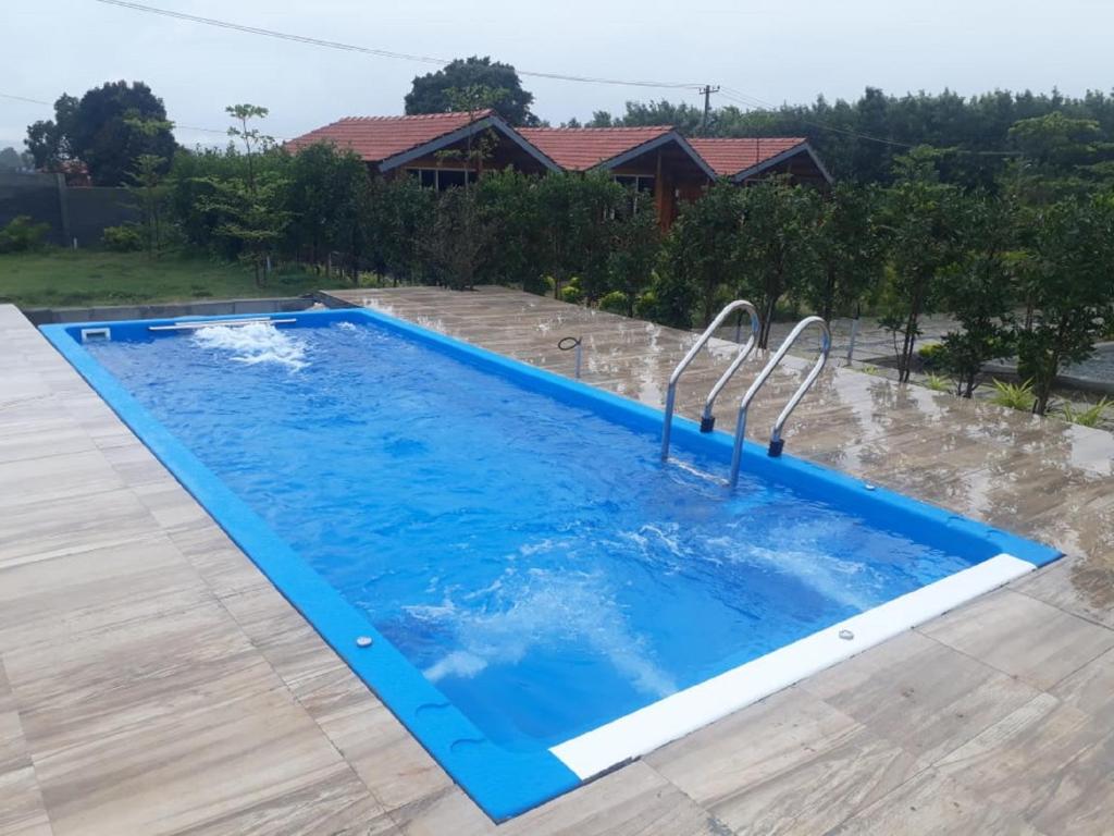 a swimming pool in the backyard of a house at Trippr Chikkamagaluru in Chikmagalūr