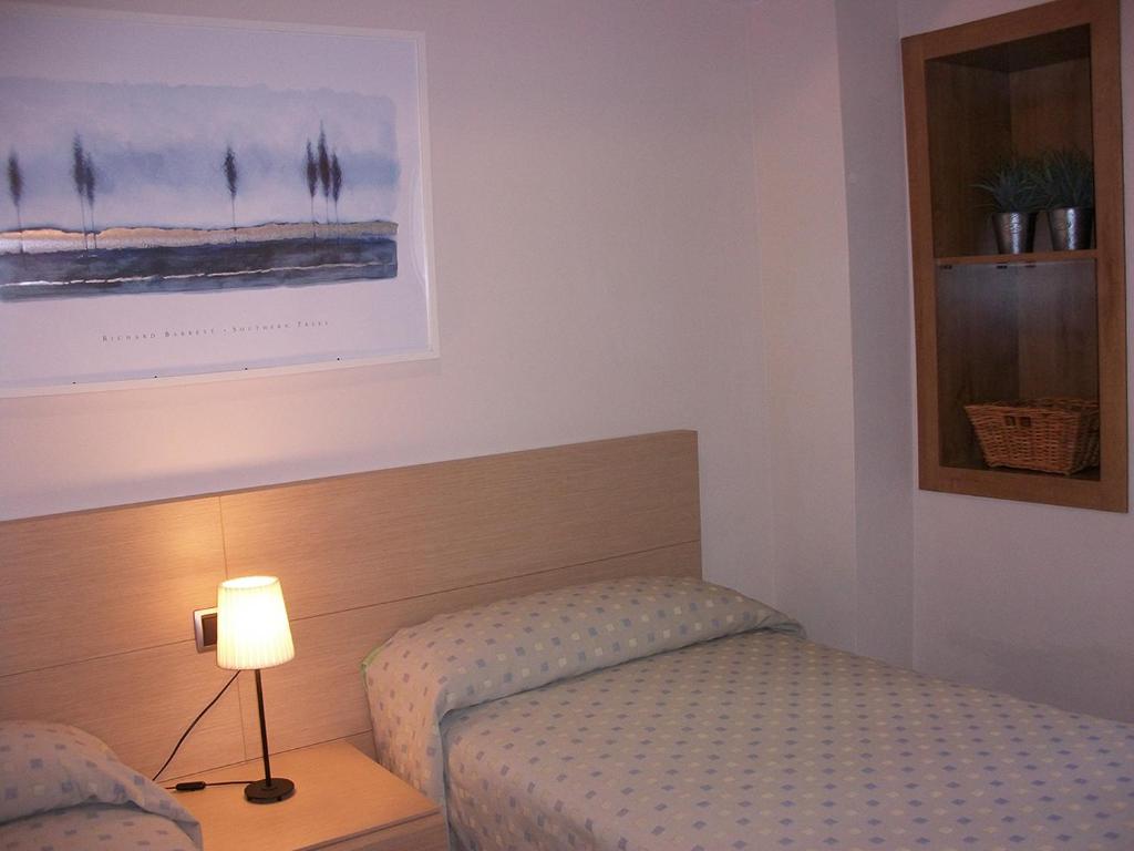 A bed or beds in a room at Apartamentos San Cristobal