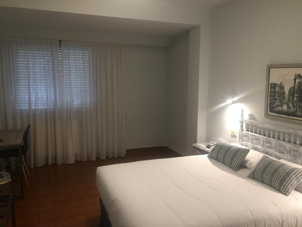 Posteľ alebo postele v izbe v ubytovaní Hotel Celanova