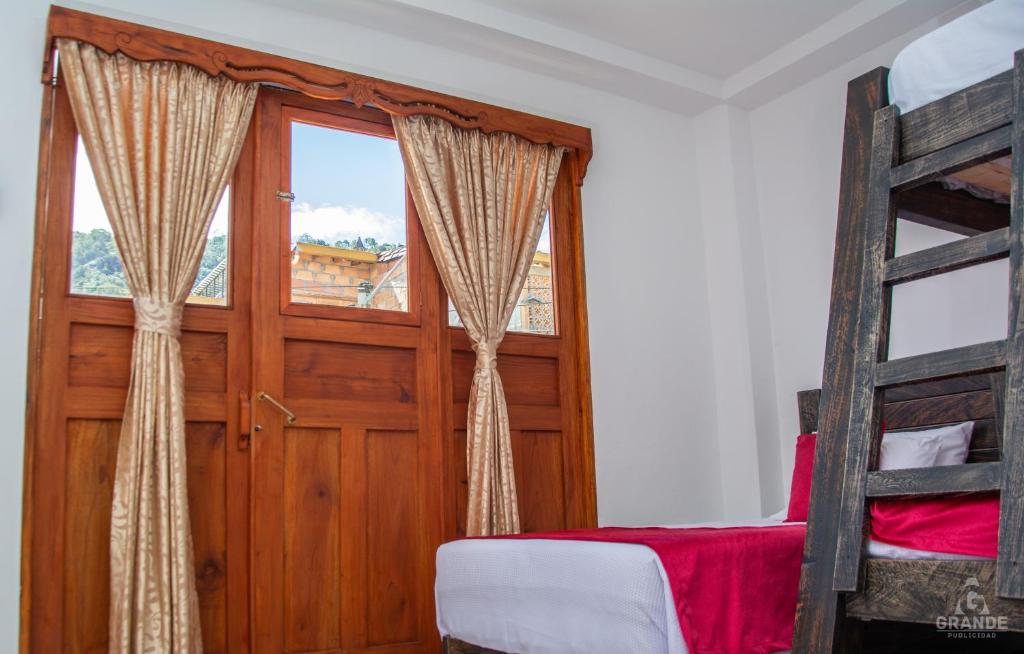 Postel nebo postele na pokoji v ubytování Hotel Madre Laura Jericó