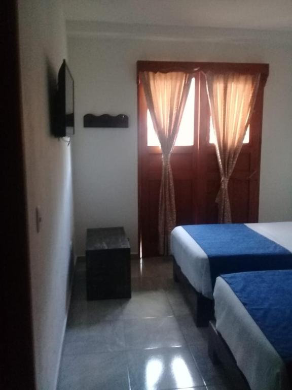 Postel nebo postele na pokoji v ubytování Hotel Madre Laura Jericó