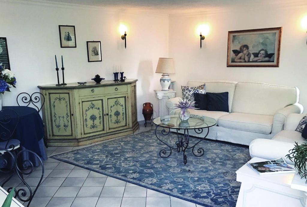 a living room with a couch and a table at Casa Anna Capri Charme in Capri
