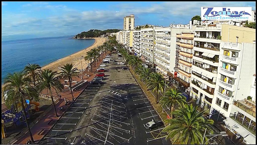 Elle offre une vue sur la plage, les bâtiments et l'océan. dans l'établissement Apartamentos Zodiac, à Lloret de Mar