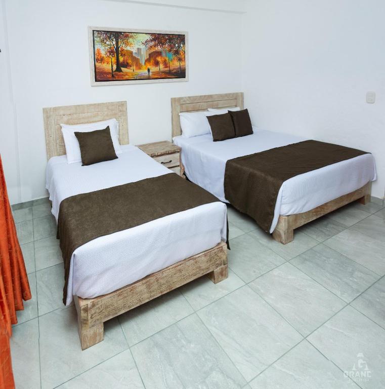 Postel nebo postele na pokoji v ubytování Hotel Madre Laura Jericó