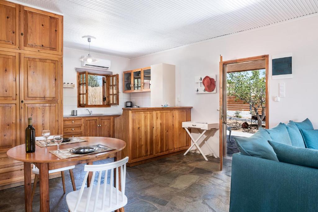 a living room with a table and a kitchen at Levanda Home in Stavros