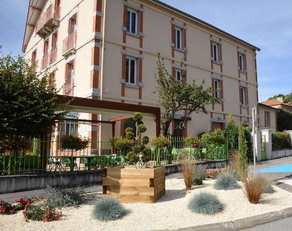 un bâtiment avec un jardin en face dans l'établissement Hotel Restaurant de la Poste, à Saint-Just-en-Chevalet