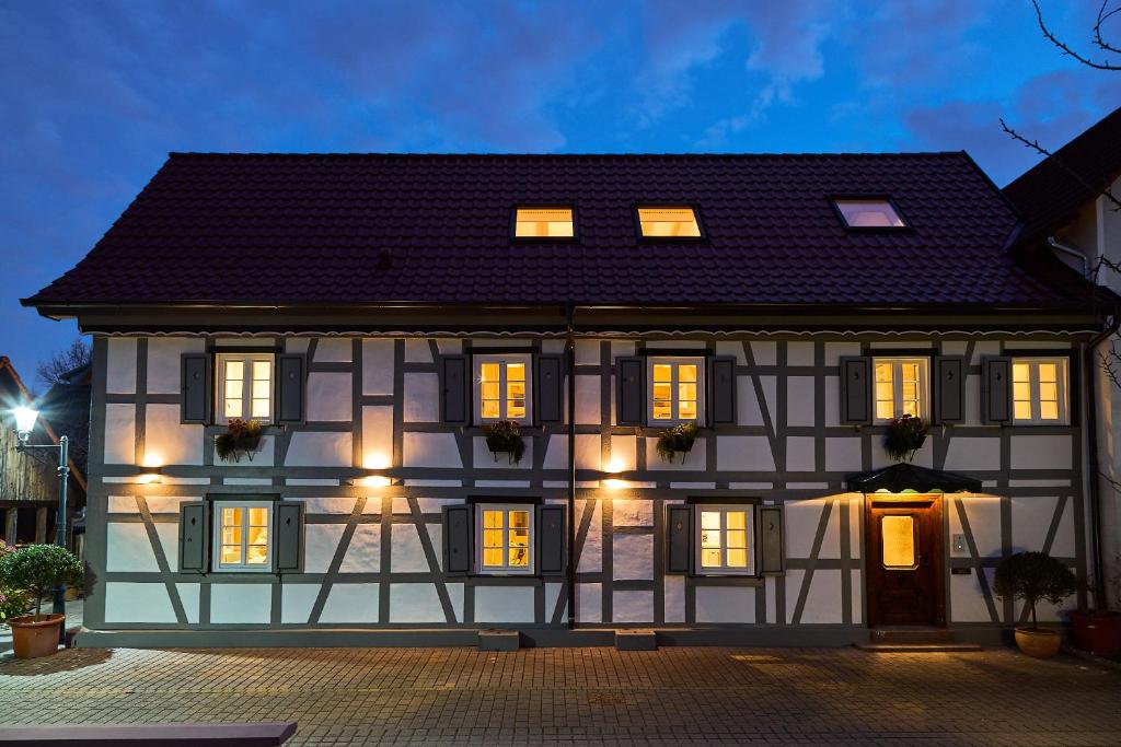 a white and black building with lights on at Die Grüne Bettlad Boutique-Hotel in Bühl