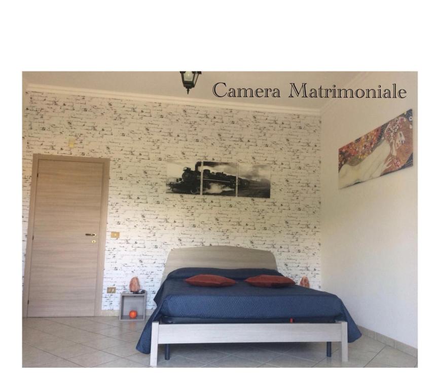 ブラッチャーノにあるCasa Vacanze La Stazioneのレンガの壁、ベッド付きのベッドルーム1室