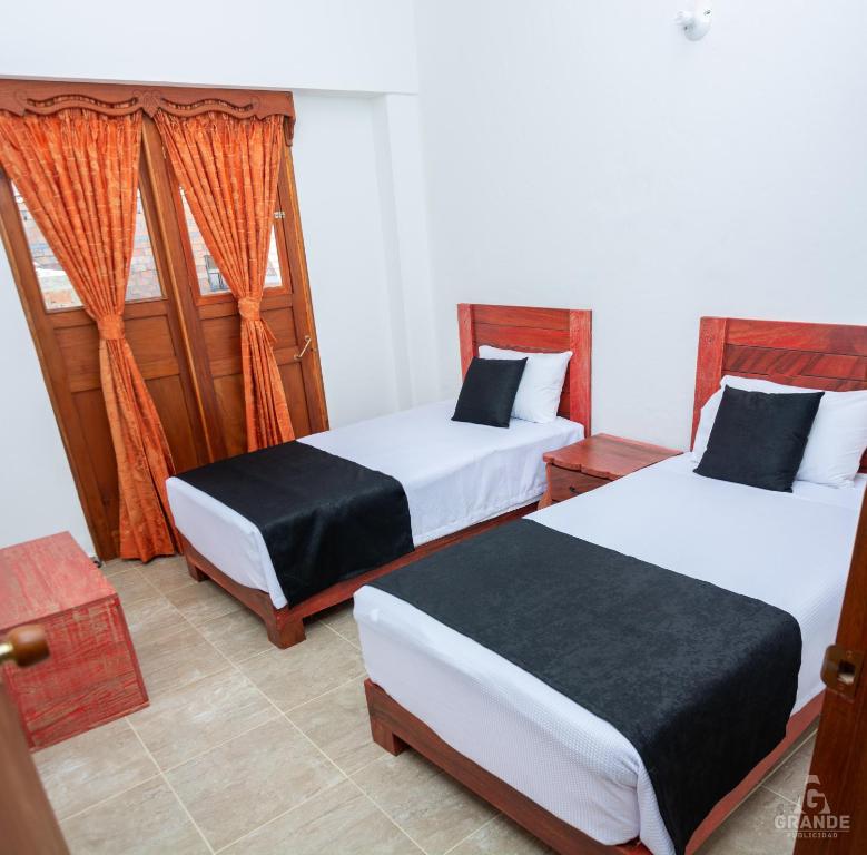 Postel nebo postele na pokoji v ubytování Hotel Madre Laura Jericó