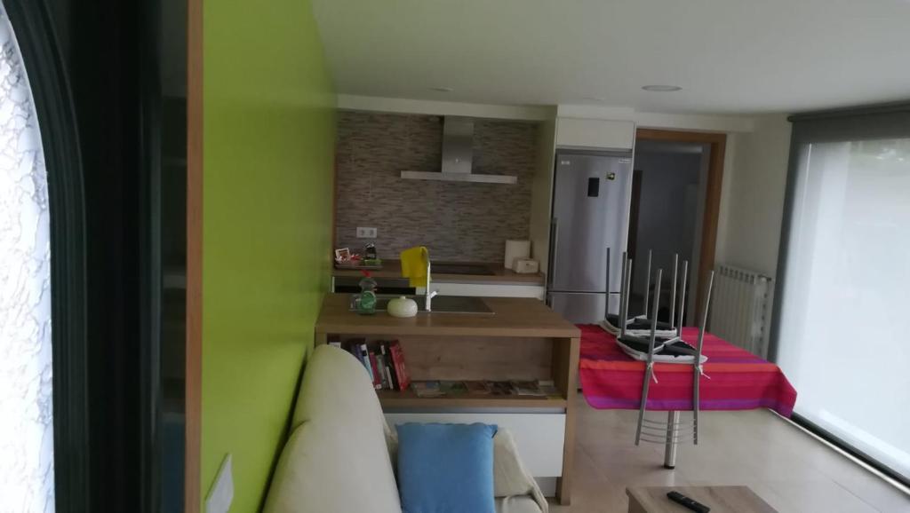 a living room with a couch and a kitchen at Apartamento Laura in Gandara