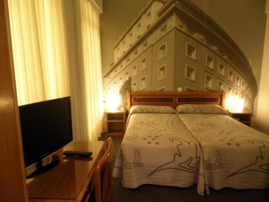 Postel nebo postele na pokoji v ubytování Hotel Photo Zabalburu
