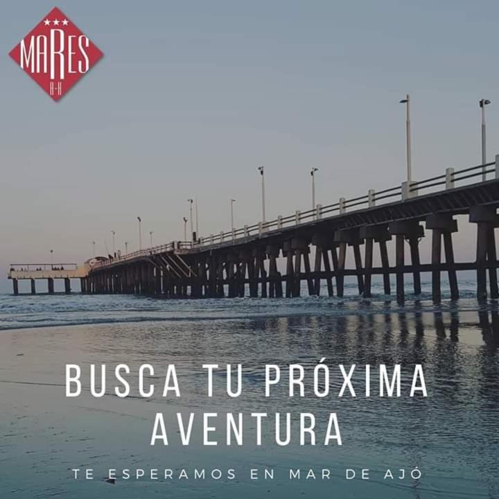 a bridge over a body of water with the words bussico tu propha at Mares Apart Hotel in Mar de Ajó