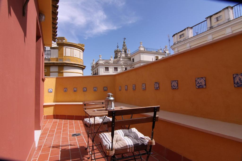 a table and chairs on the balcony of a building at Living Sevilla Apartments Catedral in Seville